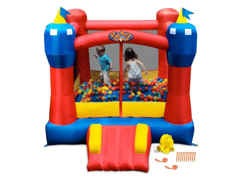 Blast Zone Magic Castle with children inside, shown with its blower and ground stakes