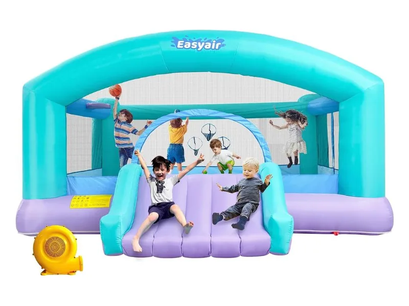 Easyair bounce house with a teal arch, a lavender base and a short slide, children jumping inside and its blower in front