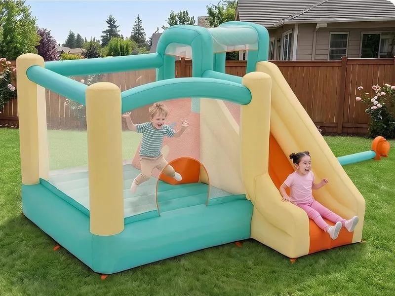 Two children on an H2OGO! Slidetastic in pastel teal and cream on a backyard lawn, one jumping and one coming down the slide