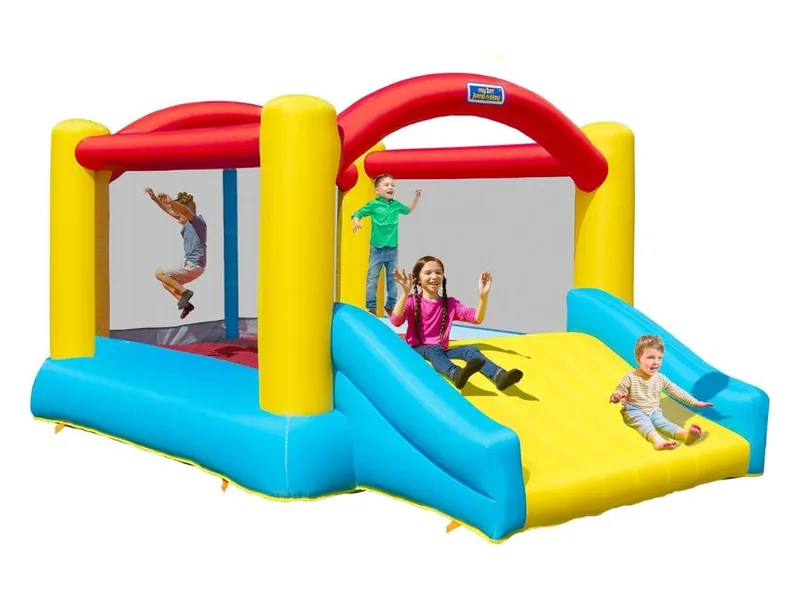 Sportspower bounce house with yellow pillars, a red arch and a wide blue and yellow slide, children jumping and sliding